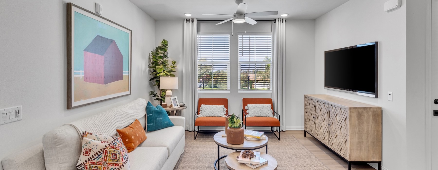 a living room with a tv and couches